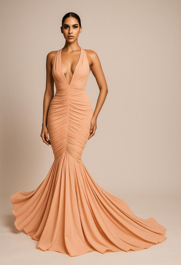 Woman wearing a peach evening gown against a beige background